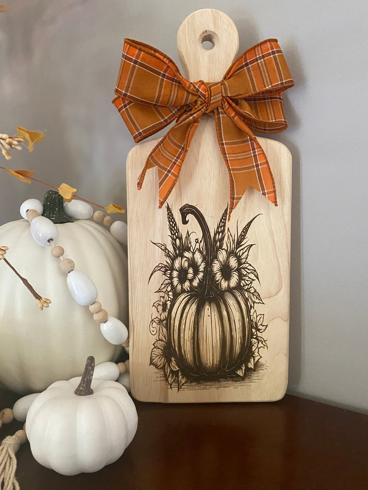 Graceful Creations by Graciela decorative wooden cutting board with engraved pumpkin design and orange plaid bow