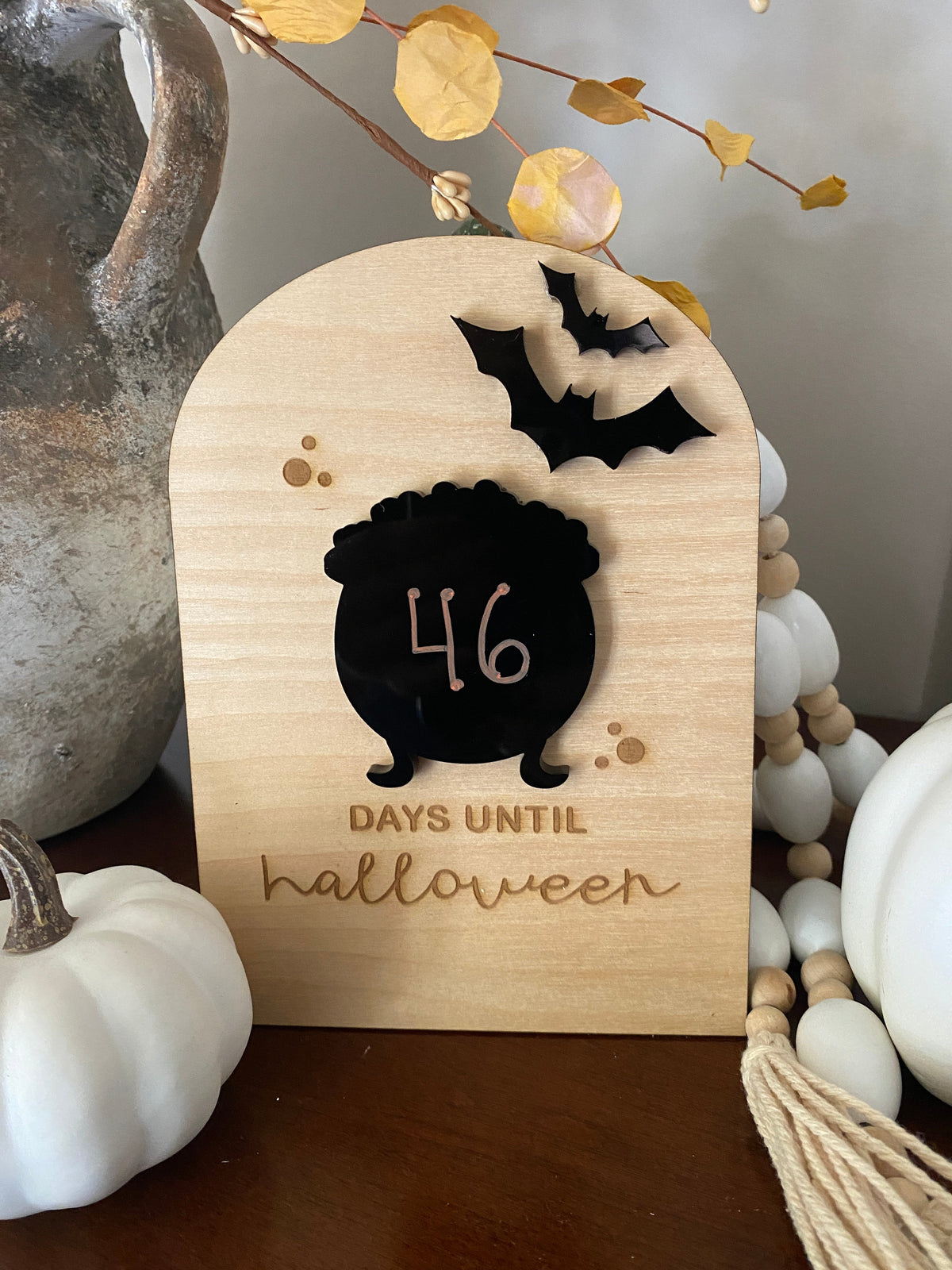 Graceful Creations by Graciela birch wood Halloween countdown sign with black acrylic cauldron and bat decorations.