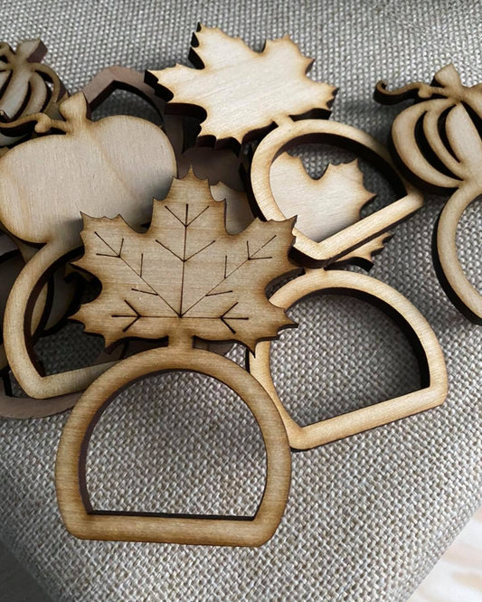 Graceful Creations by Graciela handcrafted wooden Thanksgiving napkin rings featuring maple leaf and pumpkin designs.