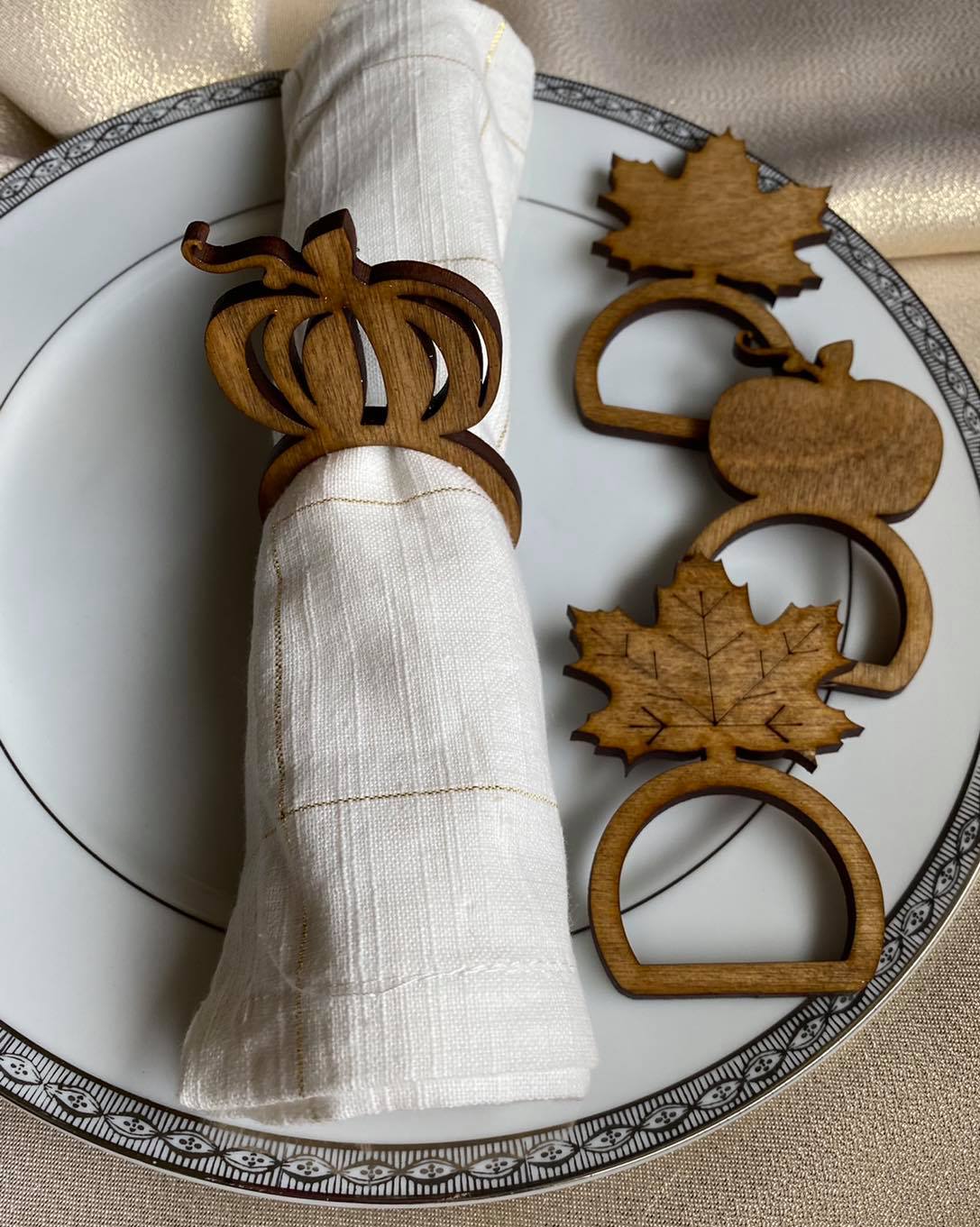Graceful Creations by Graciela handcrafted wooden Thanksgiving napkin rings featuring pumpkin and maple leaf designs.